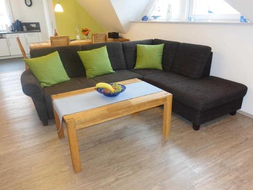 a living room with a couch and a coffee table at Ferienwohnung Regenbogenhaus in Hasselberg
