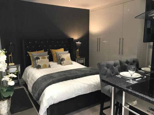 a bedroom with a large bed with a black wall at No 3 Victoria Apartment in Bowness-on-Windermere