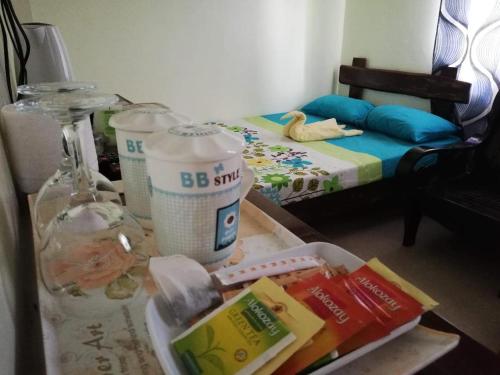 a table with food on it in a room at Balai Mariacaria Pension House in Guindulman