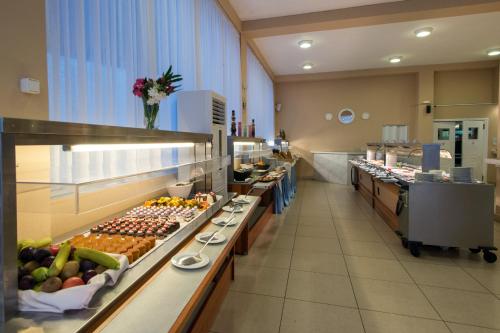 a buffet line in a restaurant with fruits and vegetables at Panorama Sidari in Sidari