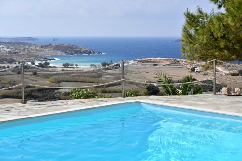 a swimming pool with a view of the ocean at Terra in Parikia
