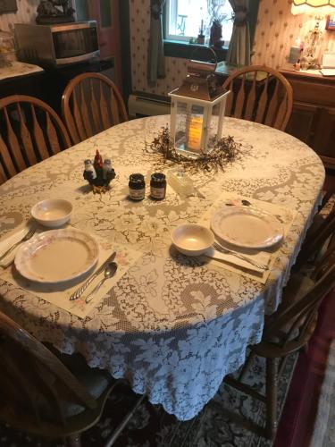 a table with a blue and white table cloth on it at Carriage Stop Bed & Breakfast in Palmyra