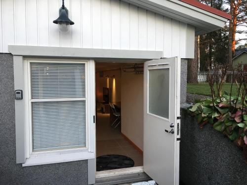 a door leading into a garage with a window at Yrjänäntie Home Apartment in Oulu