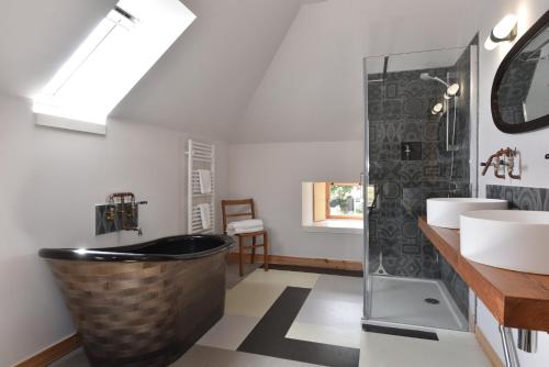 a bathroom with a large tub and two sinks at Burmieston in Perth