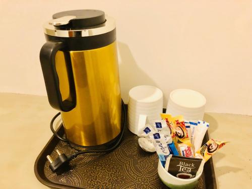 a coffee maker sitting on top of a table with chips at Tara Watergate in Tissamaharama