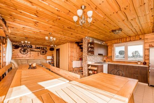 a dining room with a large wooden table in a kitchen at Edmart in Dobromislė