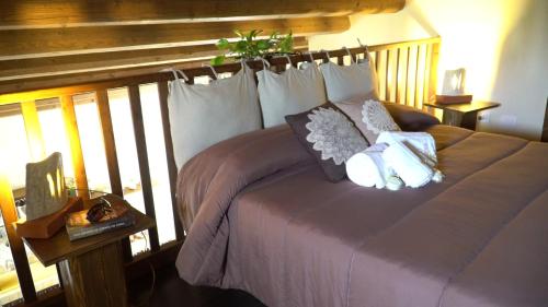 a bedroom with a bed with pillows on it at I 5 SENSI in Marina di Modica