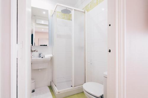 a white bathroom with a toilet and a shower at Garai Apartment by People Rentals in Bilbao