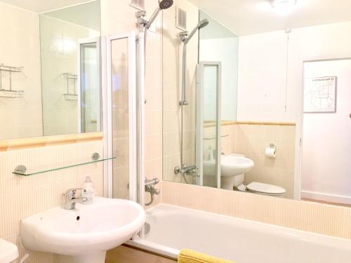 a bathroom with a sink and a tub and a toilet at Splendid Fitzrovia W1 Heart of Central London 1-Bed. Free Wifi in London