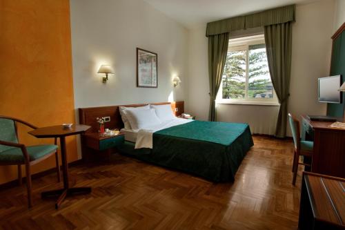 Postel nebo postele na pokoji v ubytování Grande Albergo Maugeri