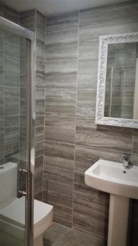 a bathroom with a sink and a toilet and a mirror at Waterside House in Southampton