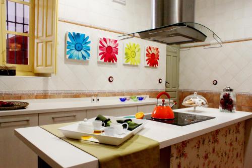a kitchen with a sink and a stove top oven at Casa Rural Doña Elisa in Torrenueva