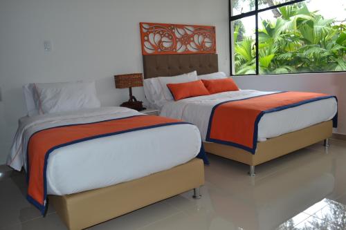 Ένα ή περισσότερα κρεβάτια σε δωμάτιο στο Hotel Yalconia