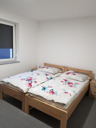 a bed with two pillows on it in a room at Apartmaji Janković in Logatec