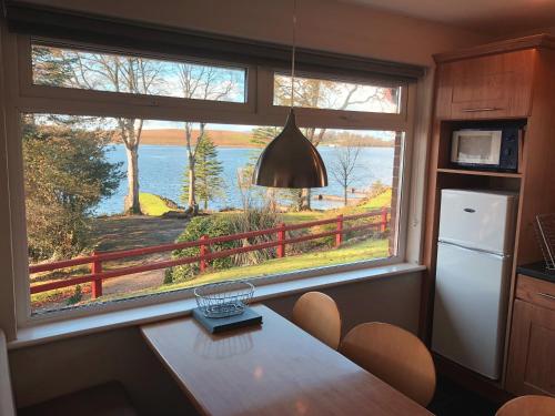 a kitchen with a table and a window with a view at Manor House Marine & Cottages in Irvinestown