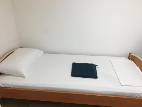 a bed with a black towel sitting on it at Palazzo Grigio in Bari