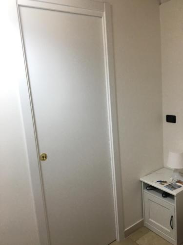 a white door in a room with a table at Palazzo Grigio in Bari