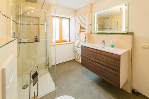 a bathroom with a sink and a shower at Schmuckhof in Siegsdorf