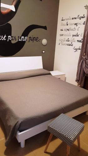 a bed in a room with a sign on the wall at La Dimora Degli Artisti in Catanzaro