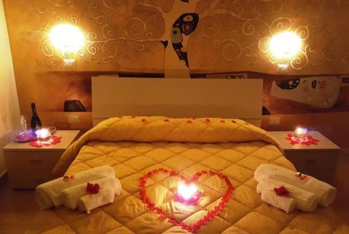 a bedroom with a bed with a heart on it at La Dimora Degli Artisti in Catanzaro