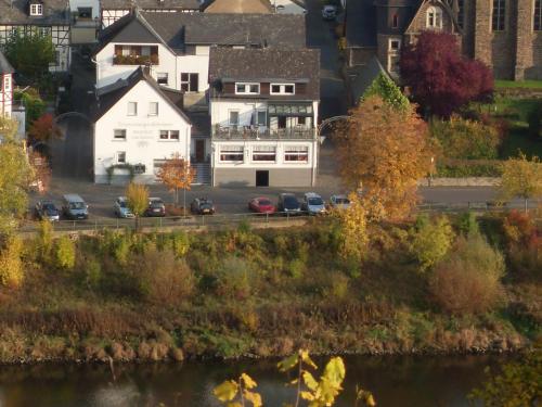 a large white house with cars parked in a parking lot at Gästehaus Mona Lisa in Neef