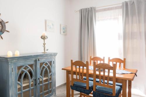 a dining room with a table and chairs and a window at Close to Everything | A/C+ WiFi | 1min Beach | in Los Cristianos