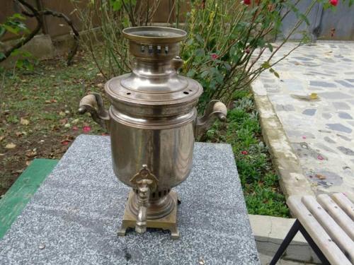 a metal object sitting on the ground next to a bench at Toma's vila in Borjomi
