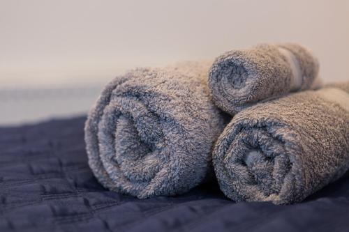 a teddy bear with its large tail on a bed at The Lighthouse Penthouse, Studio and Holiday Home in St Ives