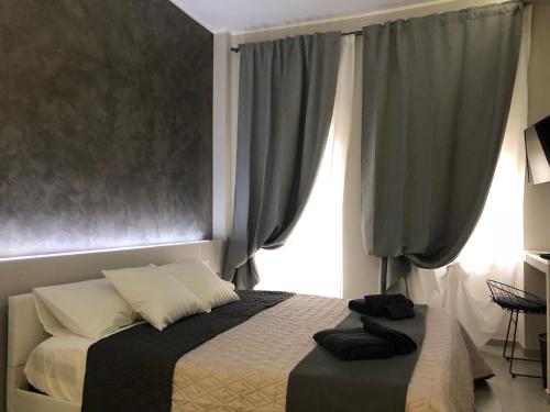 a bedroom with a bed and a window at Turin Central Rooms in Turin