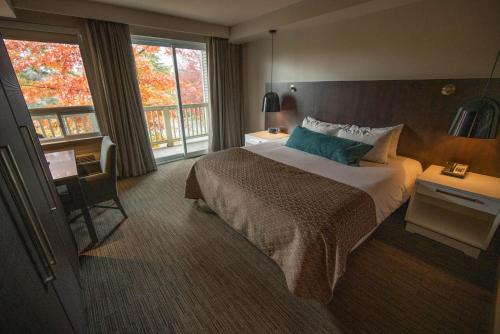 a hotel room with a bed and a window at Taboo Muskoka in Gravenhurst