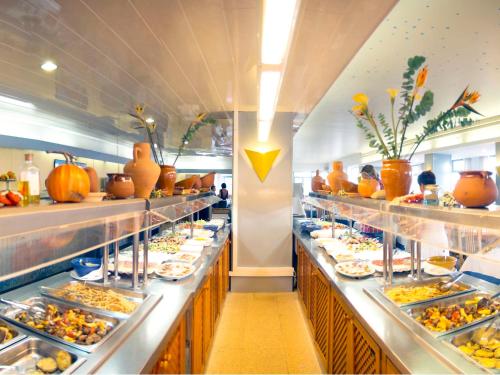 a buffet line with many plates of food at Hotel Figueretes in Ibiza Town