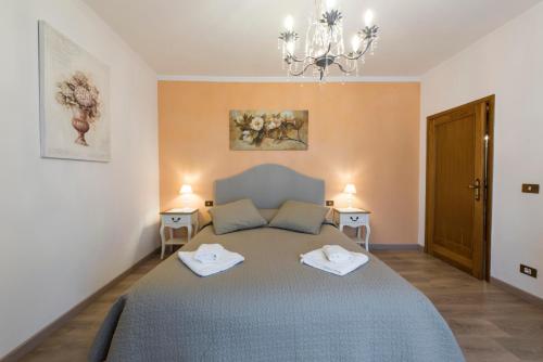 a bedroom with a bed with two towels on it at Fiesole is Magic in Fiesole