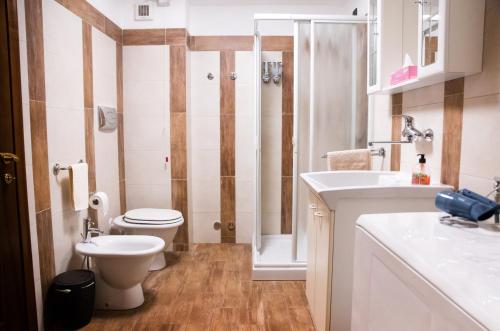 a bathroom with a toilet and a sink at B&B San Pellegrino Terme in Zogno