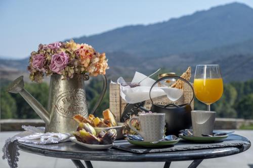 a table with a tray of food and a glass of orange juice at Longra Family Villa & SPA in Barcel