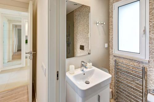 a bathroom with a sink and a mirror at Luxurious T2 apartment, Olhos Dagua in Albufeira