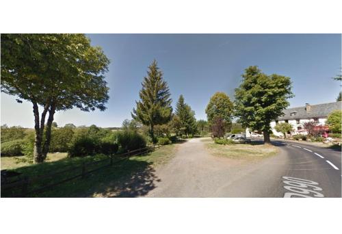 an empty road with trees on the side of the road at Auberge de Pont-la-Vieille in Narnhac