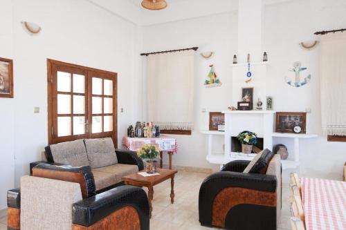 a living room with two couches and a fireplace at Glaro Garden Hotel in Rizokarpaso