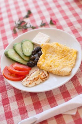 a plate of food with breakfast foods on a table at Glaro Garden Hotel in Rizokarpaso