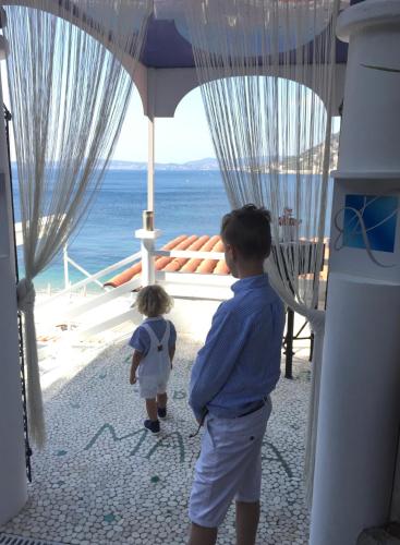 a young boy and a small child looking at the ocean at Hotel Normandy in Cap d'Ail