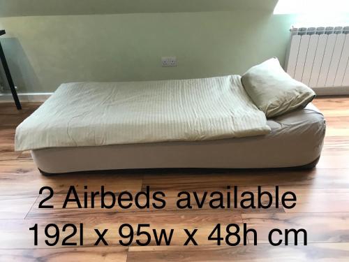 a bed sitting on top of a wooden floor at Atlantic Retreat Lodge in Kinvara