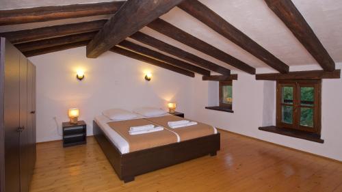 a bedroom with a bed with two towels on it at Traditional Stone House Kotli in Buzet