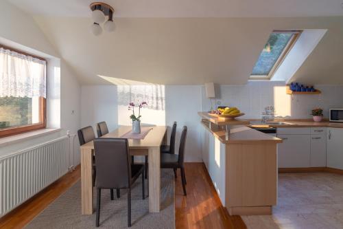 a kitchen and dining room with a table and chairs at Fine Stay Apartments in Žirovnica