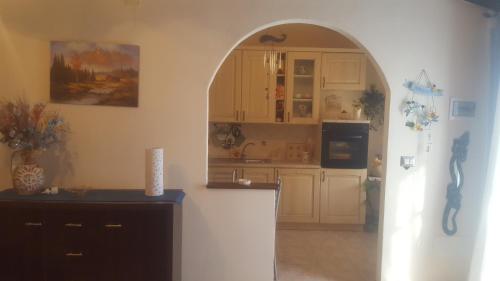 a kitchen with an archway in the middle of a room at La collina delle ginestre in Enna