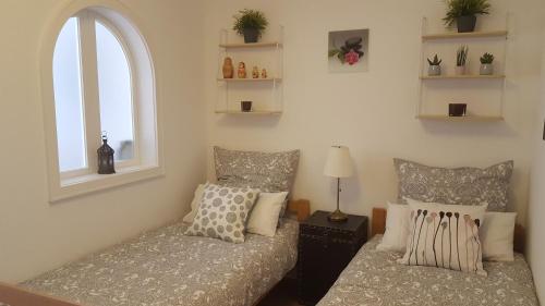 a bedroom with two beds and a window at Mountain View Apartment in Garmisch-Partenkirchen