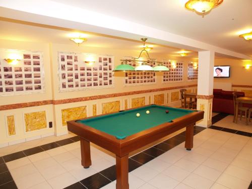 a billiard room with a pool table at Hôtel De Calais in Le Tréport