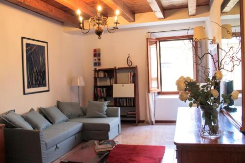 a living room with a couch and a table at Casa Mamò (Cesena Centro) in Cesena
