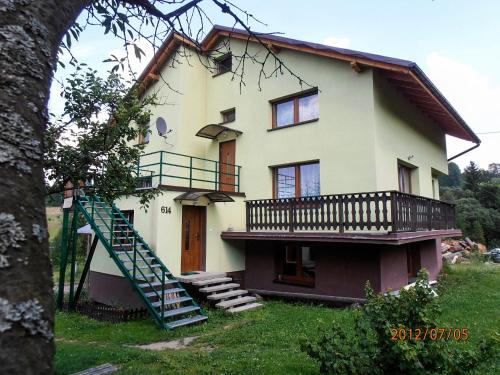 a house with a staircase in front of it at Dom Koniaków in Koniaków