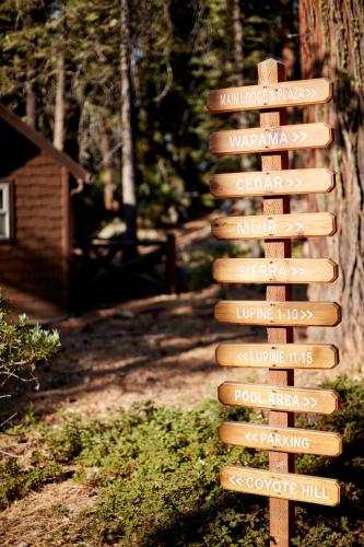 a wooden sign in the middle of a yard at Evergreen Lodge at Yosemite in Groveland