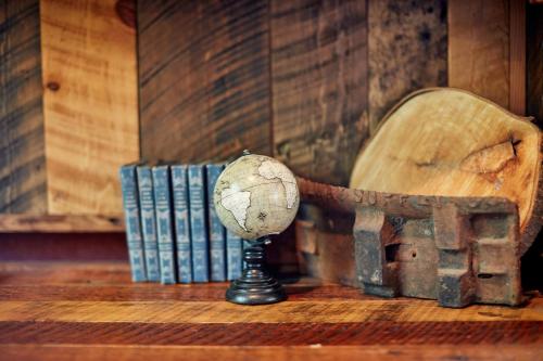 a wooden chair sitting on a table next to books at Evergreen Lodge at Yosemite in Groveland