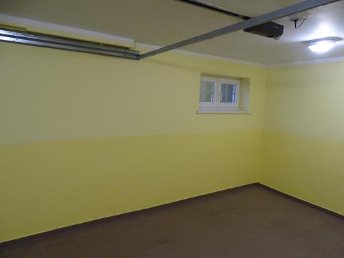 a room with a yellow wall and a window at Sobe-Apartma in Maribor